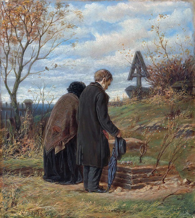 Old parents at the grave of his son